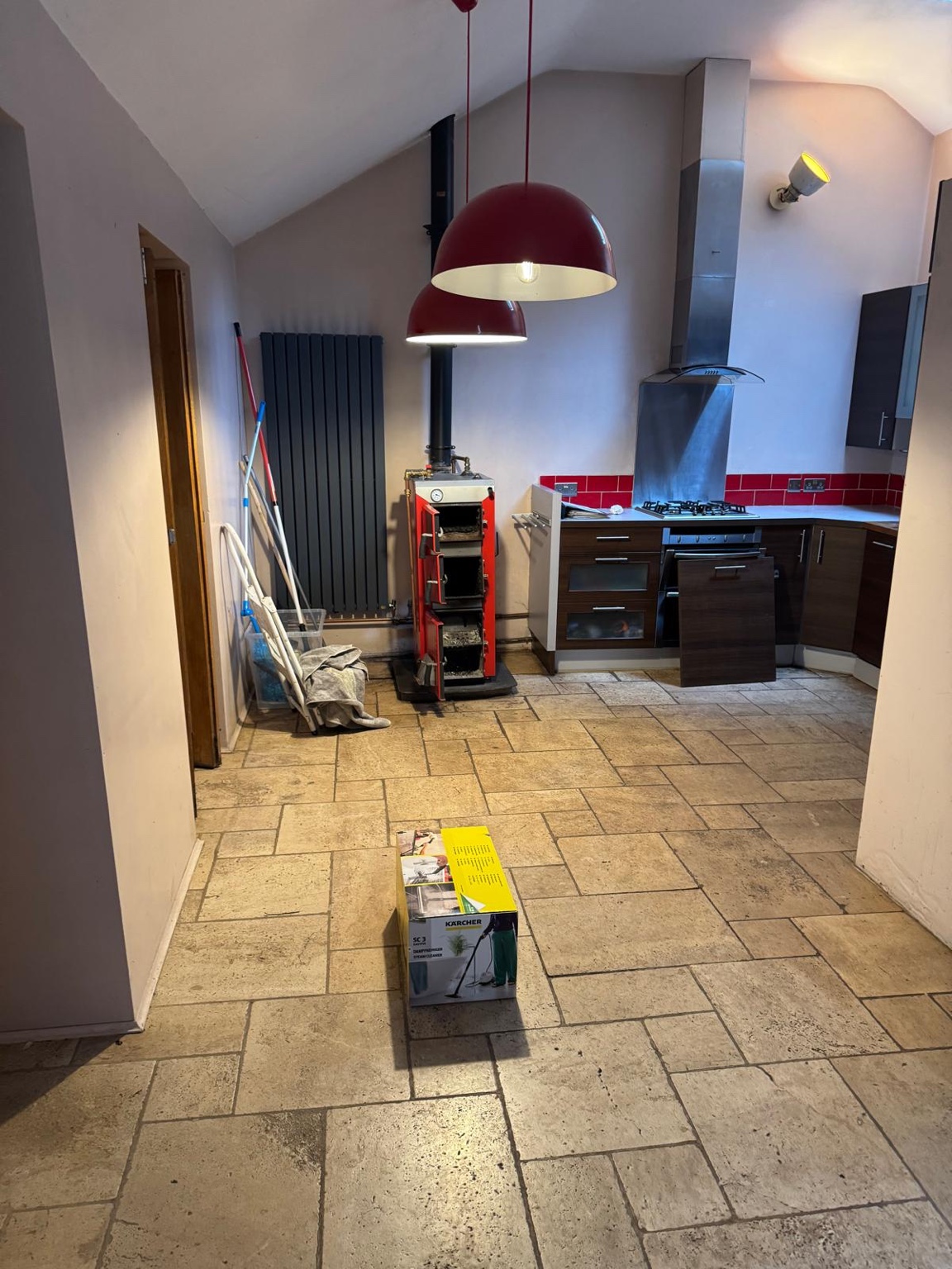Earlier open-plan cottage space with old kitchen and stove