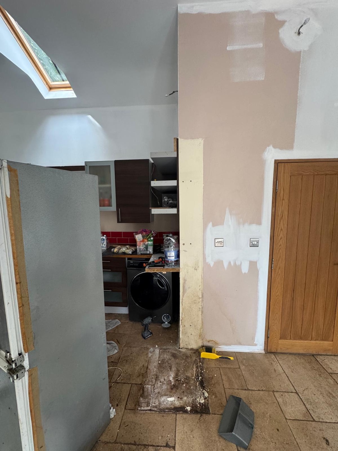 Kitchen wall during preparation with patching visible