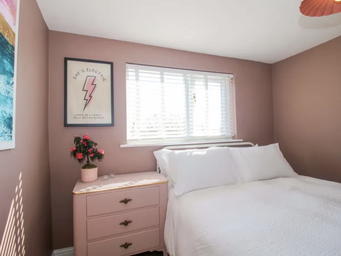 Another view of the pink bedroom and painted dresser
