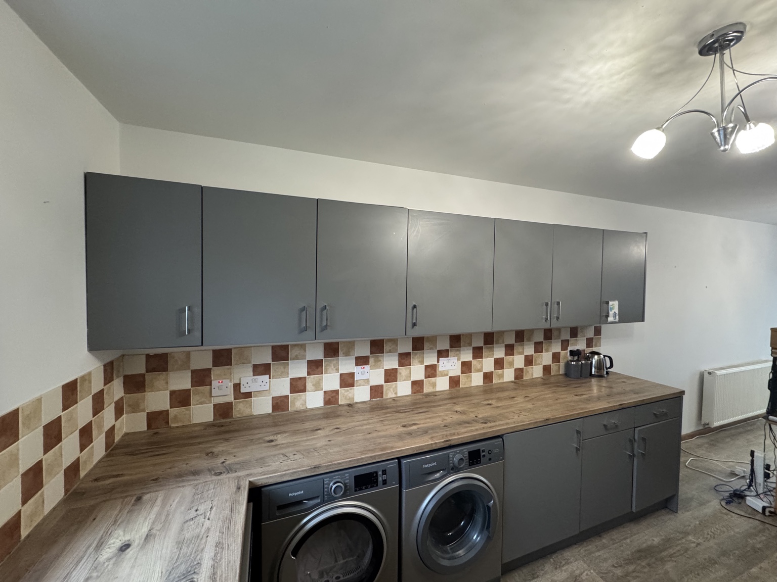 Kitchen after refresh, with clean light walls and uncovered worktop