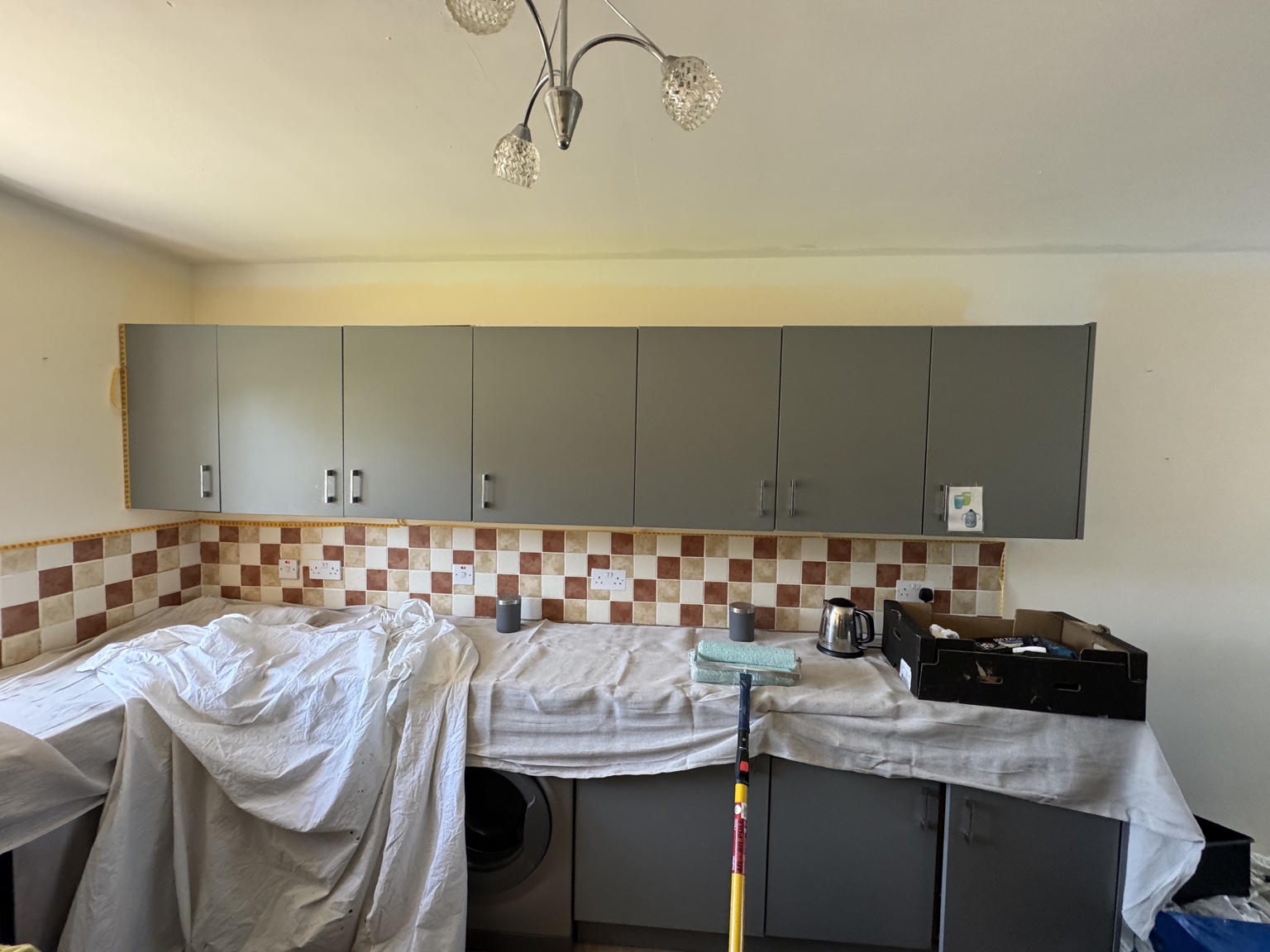 Kitchen during decorating, with counters protected