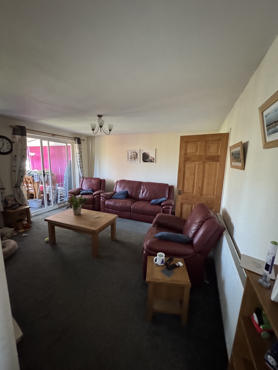 Living area before refresh with red sofas and dark carpet